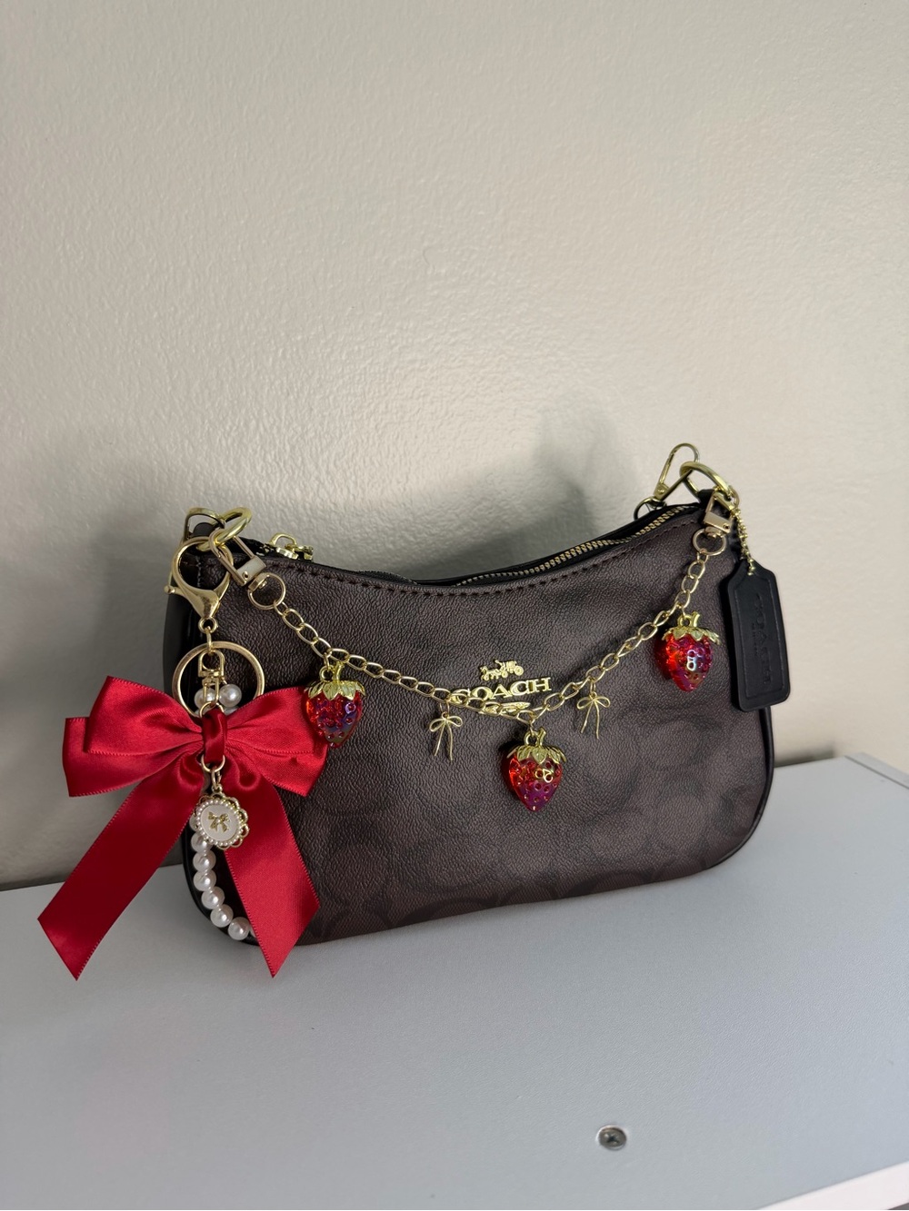Coach Brown Signature Mini Bag with Red Strawberry Charm Chain